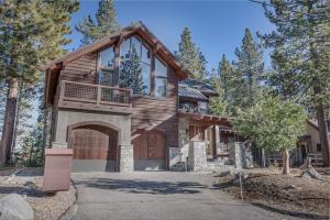 a log home with a garage and a house at Stone Peak Lodge in Tahoe City