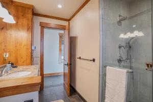 a bathroom with a glass shower and a sink at Stone Peak Lodge in Tahoe City