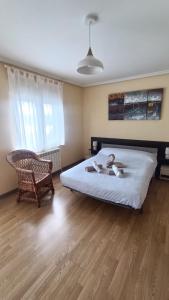a bedroom with a large bed and a chair at Casa Pepe La Granda in Trasona