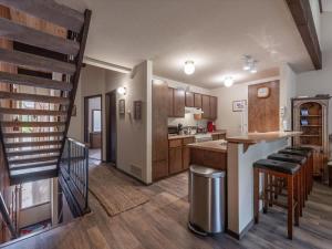 a kitchen with a stairway leading to a living room at Rooted Resort in Kings Beach