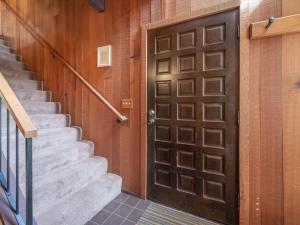 a brown door in a building with stairs at Rooted Resort in Kings Beach