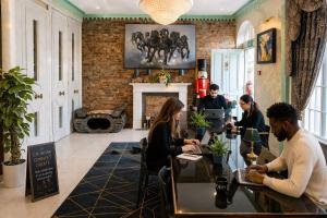 a group of people sitting at a table in a restaurant at The Rokxy Townhouses & Residences - Kings Cross in London +28 photos