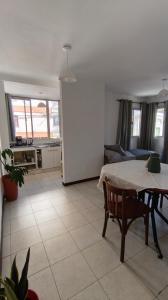 a kitchen and living room with a table and a couch at Jujuy Centro 2 in San Salvador de Jujuy