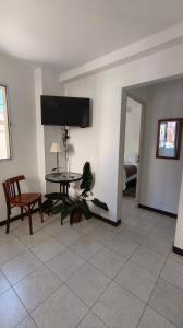 a living room with a table and a chair at Jujuy Centro 2 in San Salvador de Jujuy