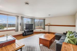 a living room with a couch and a tv at Valley View in Stowe
