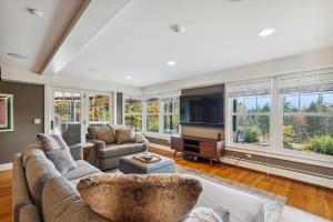 a living room with a couch and a tv at Weeks Hill Meadows in Stowe