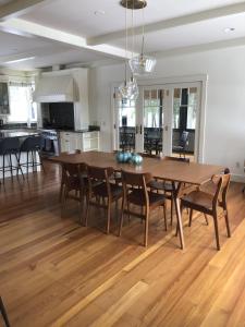 a kitchen and dining room with a wooden table and chairs at Weeks Hill Meadows in Stowe +40 photos