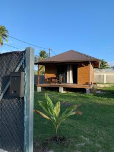 a house with a fence in front of it at Fare Teimana Vaianae in Vaianae
