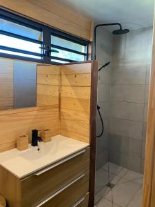 a bathroom with a sink and a shower at Fare Teimana Vaianae in Vaianae +12 photos