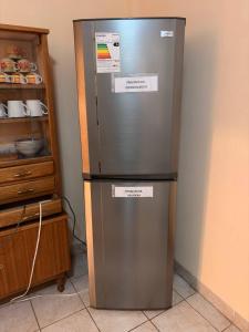 a refrigerator in a kitchen with two signs on it at Central Stay Departamentos I - Camacho in Oruro