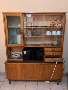 a cabinet that has a microwave in it at Central Stay Departamentos I - Camacho in Oruro