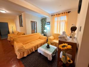 a living room with two beds and a couch at Central Stay Departamentos I - Camacho in Oruro
