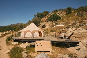 a tent in the middle of a field with a mountain at Paradise Ranch Inn - Ecstatic Tent in Three Rivers