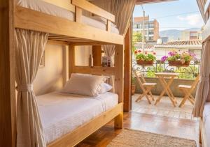 a bedroom with a bunk bed and a balcony at Paisa Hostel Medellín in Medellín +87 photos