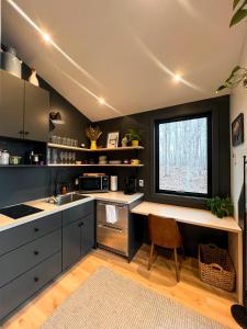 a kitchen with a counter and a window at Bison Farm - Cabin Brisa in Culpeper