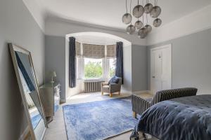 a bedroom with a bed and a large window at Drumnacree House, Alyth in Alyth