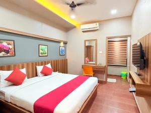 a hotel room with a bed and a television at Century Regency in Cochin +96 photos