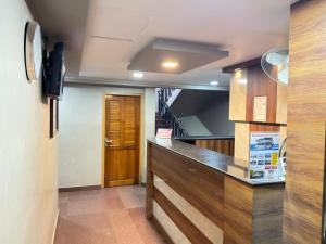 a kitchen with a counter top and a staircase at Century Regency in Cochin