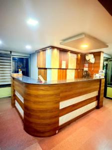 a kitchen with a wooden counter top in a room at Century Regency in Cochin
