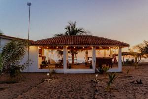 a house with a gazebo on the beach at Echoes Surf Casitas in Mechapa
