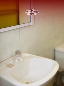 a bathroom with a white sink and a mirror at New Auto Motel in Barcelona
