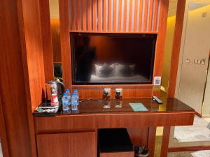 a hotel room with a large flat screen tv at فندق تمكين-TamkeenHotel- تابع لعلامة كلاديوم- A Cladium brand in Medina +16 photos