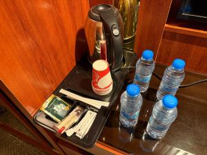 a tray with bottles of water on a table at فندق تمكين-TamkeenHotel- تابع لعلامة كلاديوم- A Cladium brand in Medina
