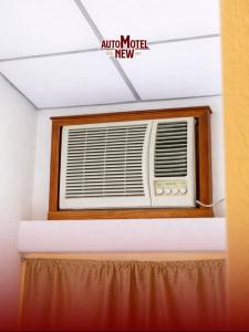 a air conditioner in a room with a window at New Auto Motel in Barcelona