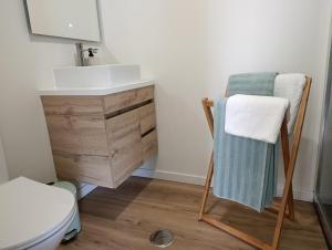 a bathroom with a sink and a towel on a chair at Casa Serra & Mar in Azeitao +43 photos