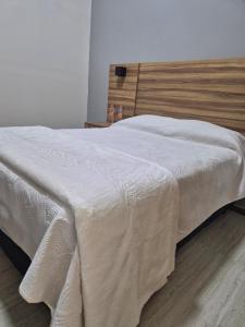 a bed with a white blanket on top of it at Hermosa Suite Anakoba 6 in La Concha +5 photos