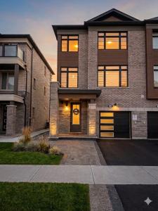 a large brick house with a sunset in the background at Keppel Circle Residence in Brampton