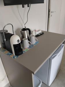 a counter with a tea kettle and a toaster on it at Carolina's Bedrooms in Trapani