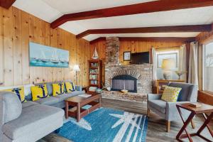 a living room with a couch and a fireplace at Oceanfront Beauty in Blaine