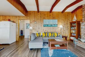 a living room with a couch and a table at Oceanfront Beauty in Blaine