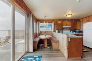 a kitchen with a table in the middle of a room at Oceanfront Beauty in Blaine +19 photos