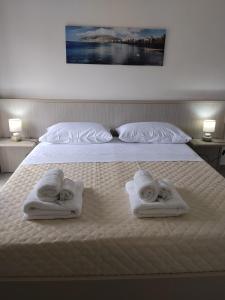 two towels on a bed with two babies on them at Carolina's Bedrooms in Trapani +20 photos
