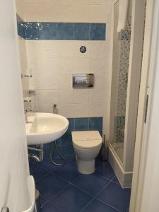 a bathroom with a toilet and a sink at Carolina's Bedrooms in Trapani