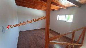 a staircase in a room with wooden ceilings at Complejo las Quintas in Santa Teresita