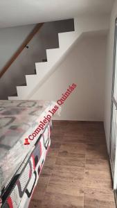 a bedroom with a bed and a staircase at Complejo las Quintas in Santa Teresita