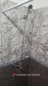 a shower in a bathroom with a marble counter top at Complejo las Quintas in Santa Teresita