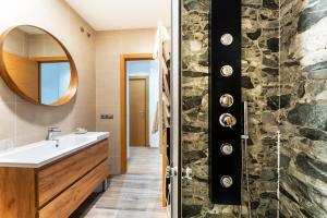 a bathroom with a sink and a shower at Infinium Zamora Suites con parking in Zamora +106 photos