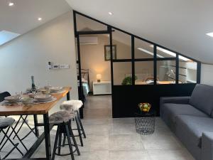 a living room with a table and a couch at Beach apartment Kostrena 2 in Kostrena