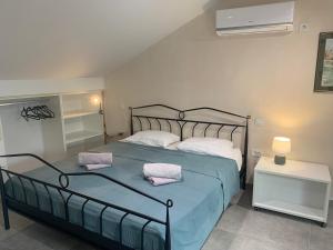 a bedroom with a bed with two pillows on it at Beach apartment Kostrena 2 in Kostrena