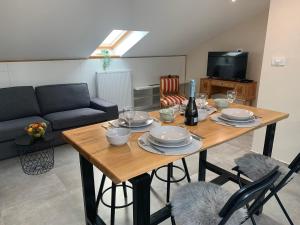 a living room with a wooden table and a couch at Beach apartment Kostrena 2 in Kostrena