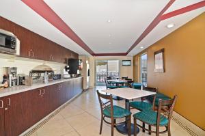 a kitchen and dining room with a table and chairs at Inn America - Lewiston in Lewiston