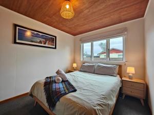 a bedroom with a bed and a window at Arrive and Revive Te Anau in Te Anau