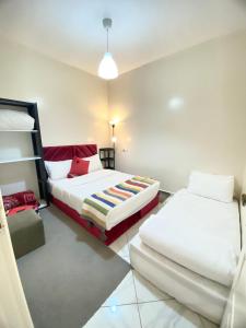 a bedroom with two beds and a lamp at Dakhla sky blue in Dakhla