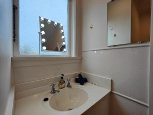 a bathroom with a sink and a window at Arrive and Revive Te Anau in Te Anau +10 photos