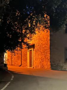 an orange brick building with a door on a street at Casetta di Pucci in Capitone