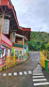 a train station on a road with a building at Los Arrieros - Hospedaje Rural in Manizales